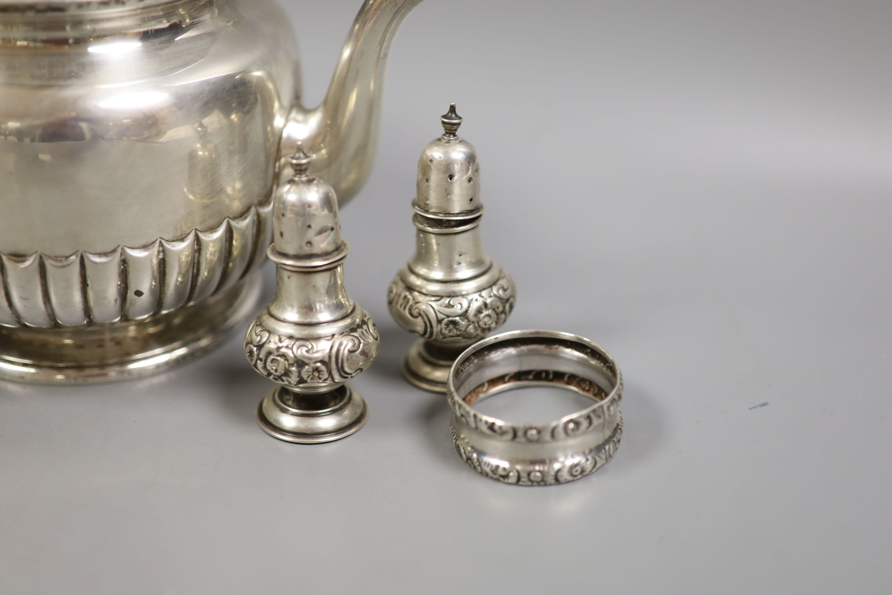 A late Victorian silver teapot, of circular half-fluted pedestal form, London 1899, Edward Barnard & Sons Ltd and a small collection of condiments